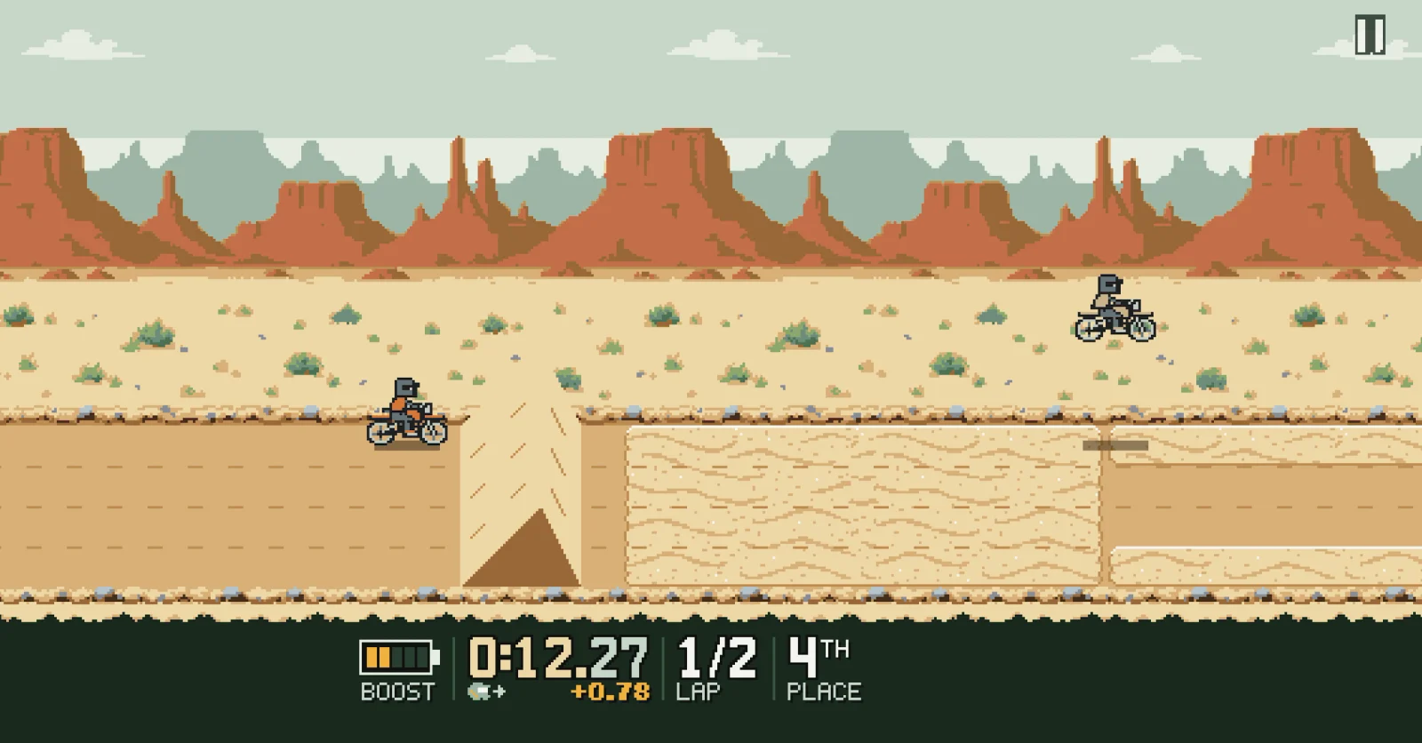 A rider in mid-air over a desert jump while a rival rides the sand below